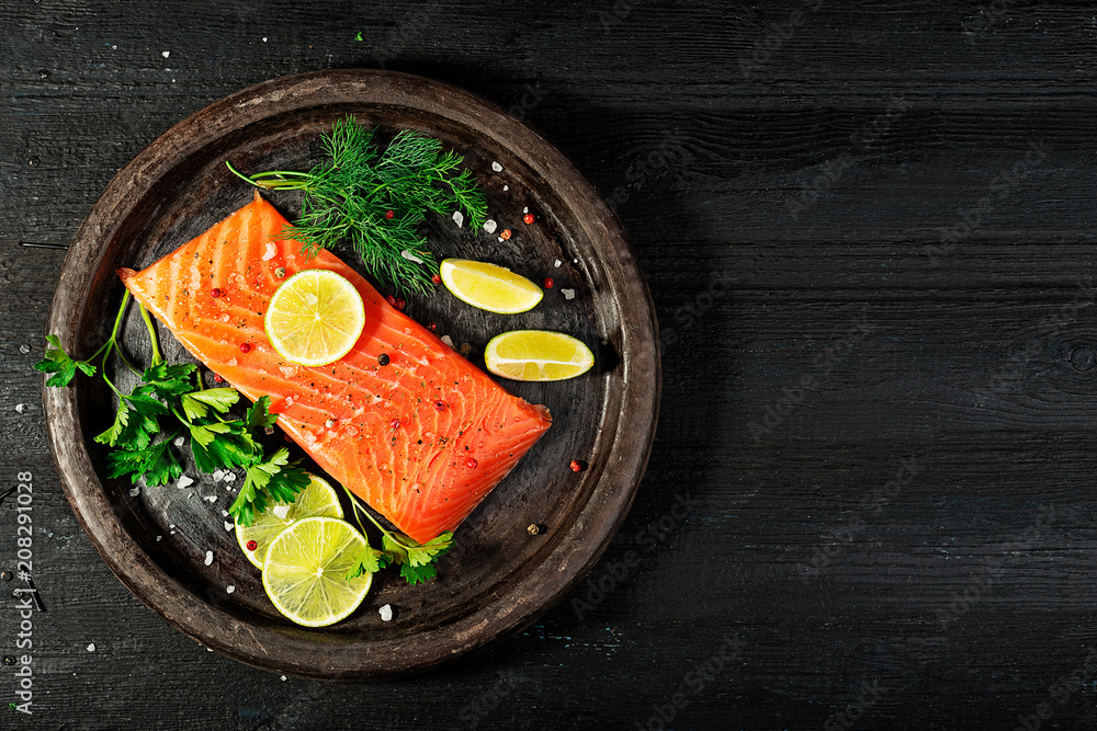 Wall mural Fresh salmon fish fillet on black background, top view