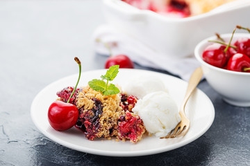 Crumble with cherry and  vanilla ice cream.