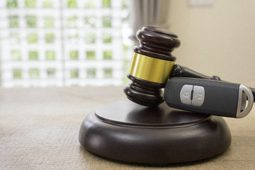 Car auction concept - gavel and car key on the wooden desk