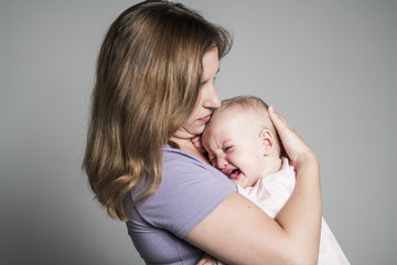 Mother trying to calm her crying baby