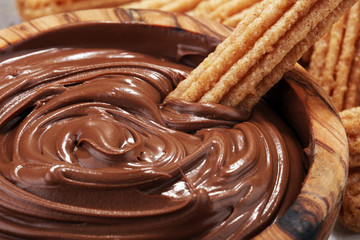 Traditional Spanish dessert churros with sugar and chocolate