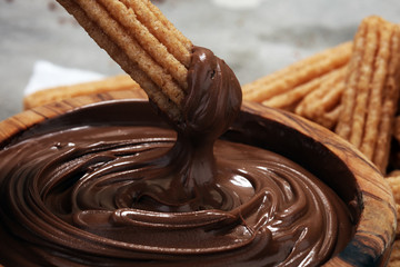 Traditional Spanish dessert churros with sugar and chocolate