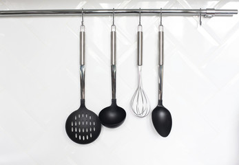 Set of cutlery hanging on wall in the kitchen