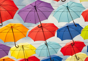Fototapeta na wymiar Colorful umbrellas background. Colorful umbrellas in the sky. Street decoration.