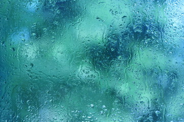 summer rain drops on window glass background texture
