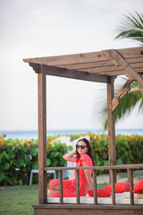 Obraz premium Relaxing and enjoying on summer vacation, woman lying in sunbed on beach