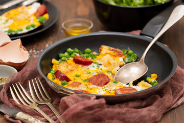 mixed egg with potato, peas and smoked sausages