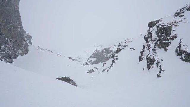 Winter hiking in rocky mountains landscape covered in snow during cold weather
