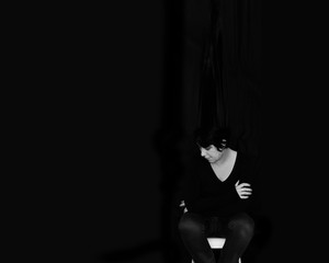 Woman dressed in black on a black background