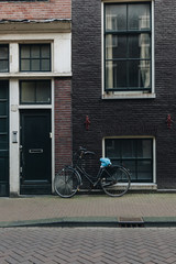 Fototapeta na wymiar facade of old building with parked bicycle, Amsterdam, Netherlands