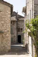 Fototapeta na wymiar a lane between old stone houses in the old city ruoms of france