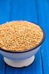 uncooked spelt in white bowl