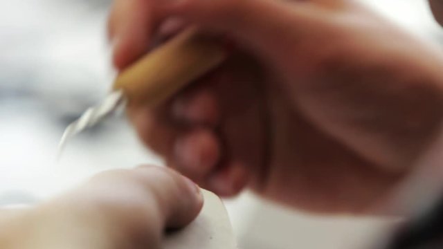 Dentist makes a dental implant prosthesis made of plaster cast. Orthopedic dentistry, prosthetics. Smile design artist working on teeth.