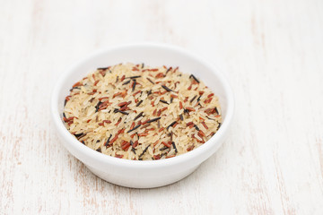 uncooked healthy rice in white bowl