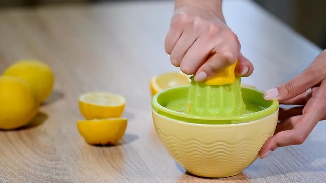 Squeezing fresh lemon juice.