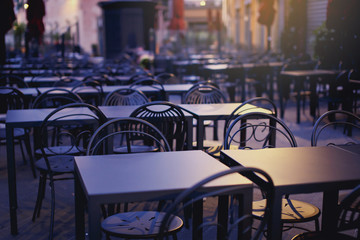 Beautiful chairs near the cafe on the street in Italy