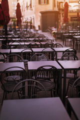 Beautiful chairs near the cafe on the street in Italy