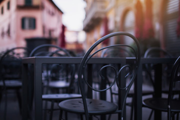 Beautiful chairs near the cafe on the street in Italy