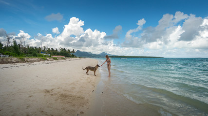 Bikini girl and shepherd on the Mauritius beach