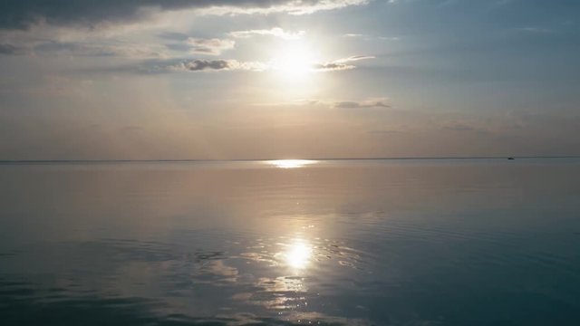 Beautiful sunset at the beach, amazing colors, light beam shining through the cloudscape over the gulf seascape. Sea and beach