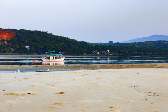Tropical beach with fishing boats, Mobor Beach, South Goa, India
