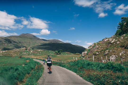 People riding bicycles on the scenic roads of Black Valley in county Kerry, Ireland