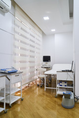 Interior of hospital room with medical ultrasound diagnostic equipment and bed. Medical concept