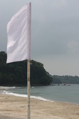 White flag on the beach