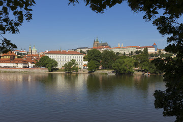 Obraz premium Spring Prague gothic Castle with the Lesser Town above River Vltava in the sunny Day, Czech Republic