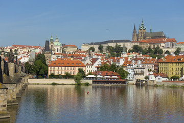 Obraz premium Spring Prague gothic Castle with the Lesser Town above River Vltava in the sunny Day, Czech Republic