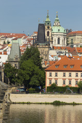 Fototapeta na wymiar Spring Prague St. Nicholas' Cathedral with the Lesser Town above River Vltava in the sunny Day, Czech Republic