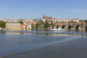 Obraz premium Spring Prague gothic Castle with the Lesser Town above River Vltava in the sunny Day, Czech Republic