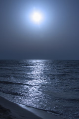 Fototapeta premium Fantastic blue sea background. Mediterranean Sea at night. Moon reflecting in a sea