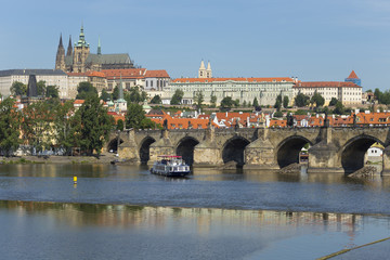 Obraz premium Spring Prague gothic Castle with the Lesser Town above River Vltava in the sunny Day, Czech Republic