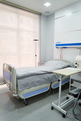 Empty Bed On Hospital Ward. Hospital room with bed and comfortable medical equipped in a modern hospital