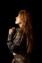 Redhead latin girl with black jacket on black background