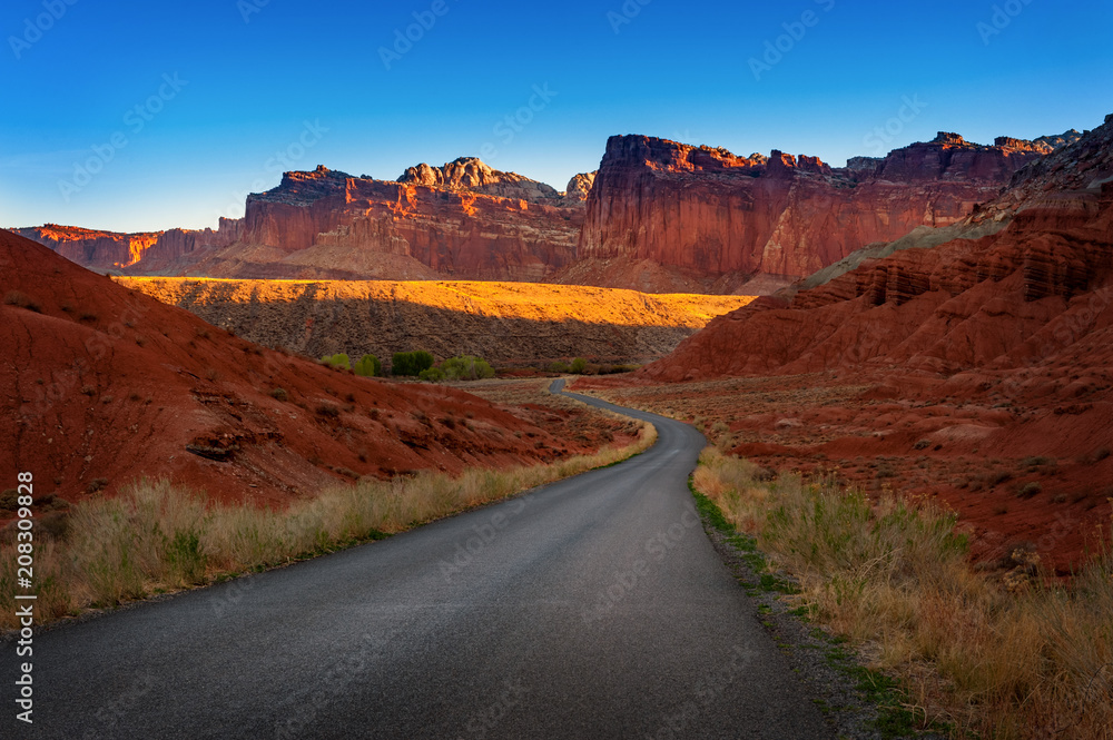 Wall mural sunrise on the capitol reef scenic drive out of fruita, utah. this 21 mile trip heads out of fruita,