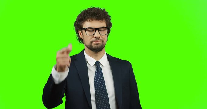 Caucasian good looking man in the glasses, suit and tie thinking and clicking fingers like found an idea. Green screen. Chroma key,