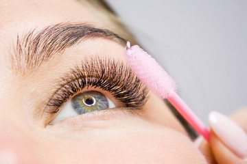 Beautiful Woman with long lashes in a beauty salon. Eyelash extension.