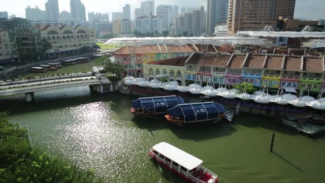 Turistic boat on Singapore River at Clarke Quay and Riverside area on a sunny day with blue sky. Singapore, Southeast Asia.