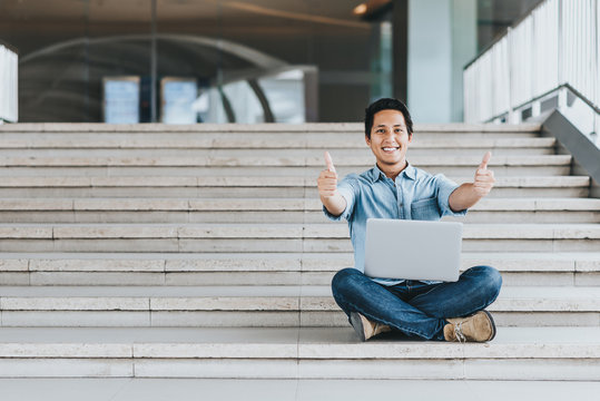 Asian Man Showing Thumb Up With Laptop