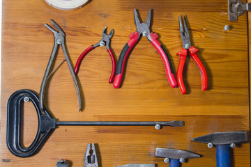 Different types of pliers on the wooden table