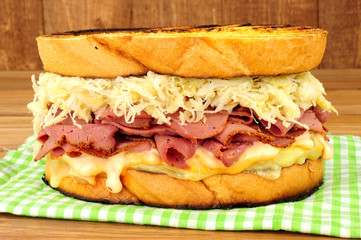 Pastrami Reuben style sandwich with sauerkraut and Swiss cheese isolated on a white background