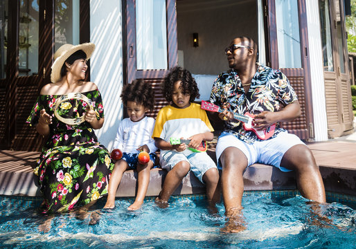 Family Playing In A Pool