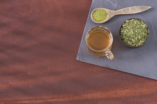 Moringa Oleifera tea with powder on table written moringa wording