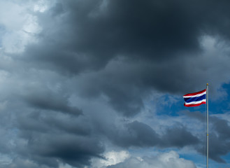Thailand flag poles and a rain cloud