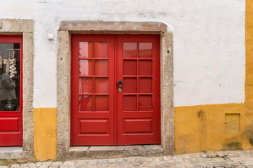 A vintage red door in an old wall