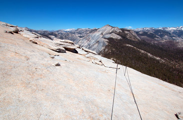 Hikers cables as seen from the top of  Half Dome in Yosemite National Park in California United States