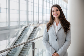 Happy smiling beautiful female business professional in a modern suit with copy space