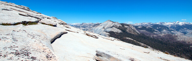 View of the High Sierra Nevada mountains from the top of Half Dome in Yosemite National Park in California United States